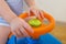 Cute Baby boy driving a toy car at home, closeup hands on rudder