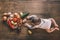 Cute baby boy lying on kitchen table near group of vegetables on chopping board