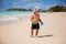 Cute baby boy playing with beach toys on tropical beach