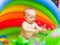 Cute baby boy playing with bubbles in a kiddy pool