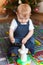 Cute baby boy playing infront of Christmas tree.