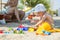 Cute baby boy playing toys on beach.