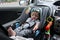 Cute baby boy sitting on car seat safety belt lock protection for drive road trip travel