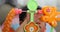 Cute baby boy using finger hand playing colorful toy hanging overhead