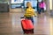 Cute  baby boy waiting boarding to flight in airport transit hall near departure gate. Active family lifestyle travel by air with