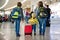 Cute  baby boy waiting boarding to flight in airport transit hall near departure gate. Active family lifestyle travel by air with