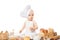 Cute baby chef in the kitchen make pizza in chef suit. Cooking child lifestyle concept. Toddler playing