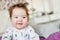 Cute baby, close up. Portrait of a crawling baby on the bed in her room