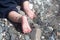 Cute baby feet with sweet fingers and heels. Baby is crawling on the shingle beach