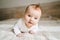 Cute baby ginger hair close up crawling on bed smiling