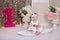 Cute baby girl 1-2 year old sitting on floor with pink balloons in room over white. Isolated. Birthday party. Celebration. Happy b