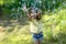 cute baby girl catches a lot of soap bubbles on a summer day