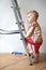 Cute baby girl climbing on a step ladder indoors