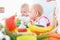 Cute baby girl eating healthy solid food in a modern daycare cen