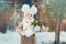 Cute baby girl enjoying winter walk in snowy park, wearing warm hat