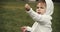 Cute baby girl exploring a park in late spring.