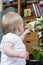 Cute baby girl inspecting a white flower