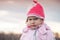 Cute baby girl in pink hat angry frowns