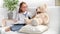 Cute baby girl playing doctor medical job listening breath heartbeat of illness bear toy white room