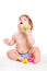 Cute baby girl plays with rubber toys