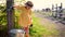 Cute baby girl pouring tap water, filling the bucket on a farm, countryside lifestyle