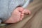 Cute baby heels and toes peeking out from under the blanket. Closeup heels of a child. Baby feet