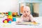 Cute baby looking and reading a book.