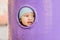 Cute baby looking into a round hole