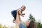 Cute baby on mom`s hands outside. Family in the park in summer. Denim style. Mom and daughter in jeans