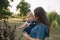 Cute baby on mom`s hands outside. Family in the park in summer. Denim style. Mom and daughter in jeans