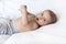 Cute baby nine months preparing for bed, yawning on the bed. The little boy is resting. A white background with copy space