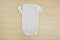 Cute baby onesie on wooden background