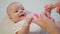 Cute Baby is playing with Mother`s Hands Smiling Surprising