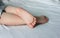 The cute baby`s feet. The toddler is sleeping on the bed. The girl. Closeup