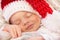 Cute baby Santa smiling in the sleep