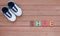 Cute baby shoes on wood plank, Little shoe on wood floor with copy space, Top view