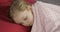 Cute baby sleeping on the bed at home. Little girl sleeping in morning light