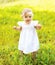 Cute baby walking on the grass in sunny summer