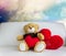 Cute bear doll sit with red heart in dreamy sweet rainbow sky