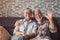 Cute and beautiful couple of old people smiling and looking at the camera and talking at home together. Portrait of seniors