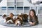 Cute beautiful girl lying on the floor with the puppies English bulldog