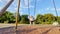 Cute beautiful little girl ride sitting on swings at playground