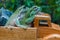 The cute behavior of two green frogs on the back of a wooden toy truck