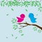 Cute Birds couple sweet on tree branch with blue background.