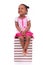 Cute black african american little girl seated in a stack of boo
