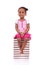 Cute black african american little girl seated in a stack of boo