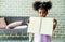 Cute black african american little girl showing self drawn painting,  African people - Children