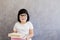 Cute blackhair little girl with books