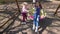 Cute blond girl child swing her mom on round outdoor swing. Gimbal motion