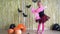 Cute blond girl have a halloween party. Female child dancing in decorated room